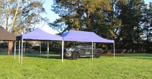Altegra Heavy Duty 4x4 Marquee and 4x8m Marquee image sheltering a parked truck showing its huge marquee coverage span.